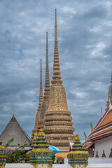 Fototapeta premium Architecture surrounding the grand War Pho temple in Bangkok, Thailand, the temple of the reclining Buddha