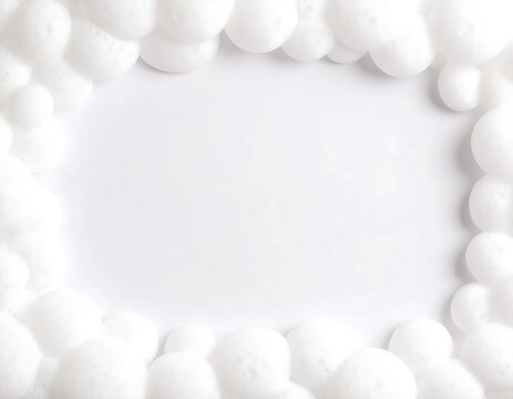 Close-up view of fluffy, white bubbles bordering a clean, white, rectangular void