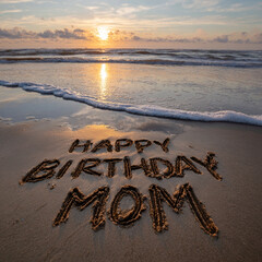 Happy Birthday Mom Handwritten in Mirror Wet Sand with Golden Sun Reflection, Approaching Wave and Pastel Sky Glow &ndash; great for inspirational wall art