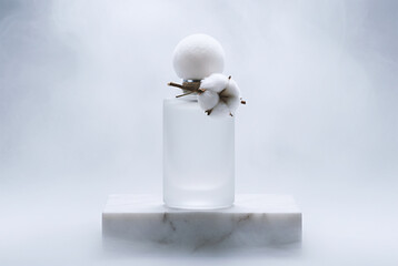 Cotton perfume stands in the fog on a white marble stone