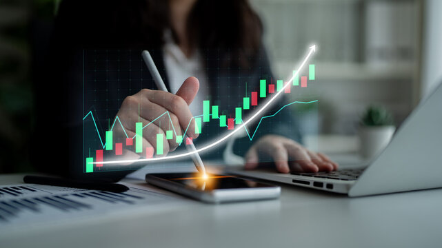 A business professional analyzes market data trends using a smartphone and detailed graphs, showcasing the intersection of technology and financial strategy. Impute - Powered by Adobe