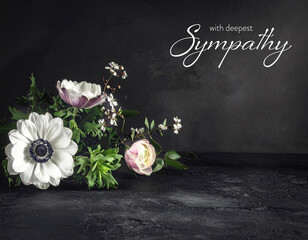Sympathy card with bunch of flowers on dark background