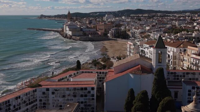 alt flying over church towards beach of Sitges Spain
