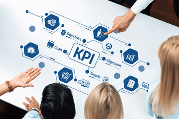 This image showcases a collaborative business environment where professionals analyze and discuss key performance indicators (KPI) for strategic goal alignment and success evaluation. Amity