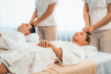 Caucasian couple enjoying relaxing anti-stress head massage and pampering facial beauty skin...