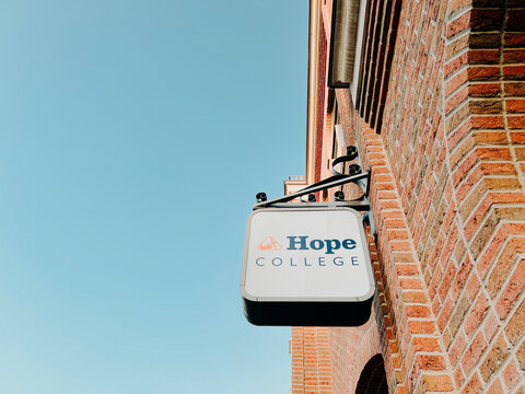 Holland, Michigan, USA, June 21, 2025 :  Low angle view of signage for Hope College in Downtown Holland Michigan. Hope College is a private Christian liberal arts college with Dutch heritage.