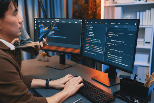 Serious of IT developers discussing intelligent website development coder system running data online two screens with laptop showing information network at neon light room at modern office. Infobahn. - Powered by Adobe