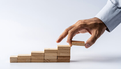 Businessman building career steps with wooden blocks