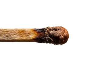 Macro close-up of a burnt matchstick head and wooden shaft, showing charred and blackened textures from combustion. Highlights the effects of fire on wood.