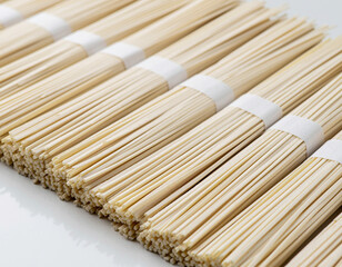 Bundled dry rice noodles arranged in rows