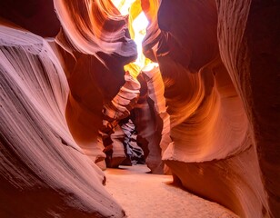 Narrow slot canyon with sunlit openings and swirling red rock formations