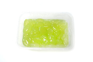 Candied kolang-kaling, or preserved green sugar palm fruit, is a traditional Indonesian dessert, isolated on white background