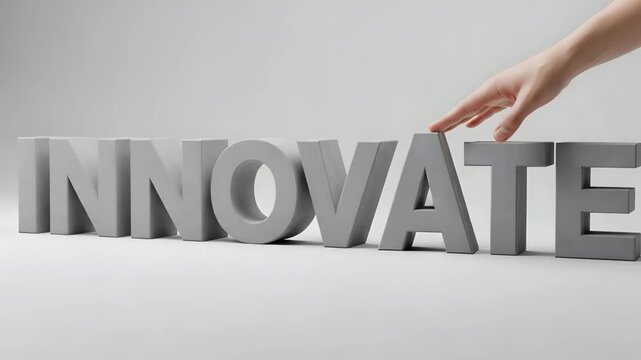 Hand placing final letter on innovative word