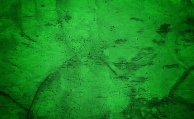 Vivid, textured green surface with pronounced cracks creates a bold abstract backdrop. Ideal for nature-inspired, eco-friendly, or modern design projects needing a striking green texture.