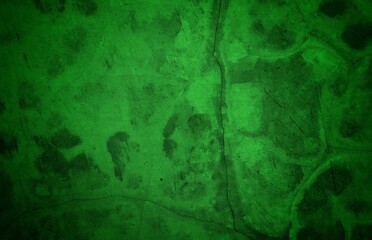 Vivid, textured green surface with pronounced cracks creates a bold abstract backdrop. Ideal for nature-inspired, eco-friendly, or modern design projects needing a striking green texture.