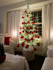 Beautiful red ornaments and white lights on a family Christmas tree