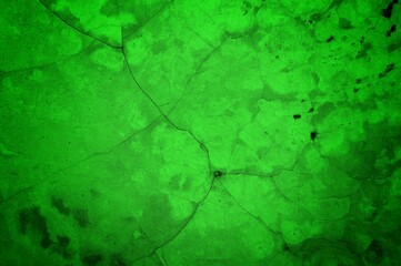Vivid, textured green surface with pronounced cracks creates a bold abstract backdrop. Ideal for nature-inspired, eco-friendly, or modern design projects needing a striking green texture.