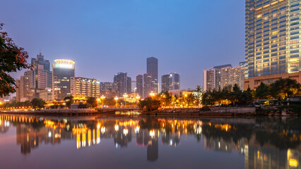 Twilight Cityscape with Reflection on River