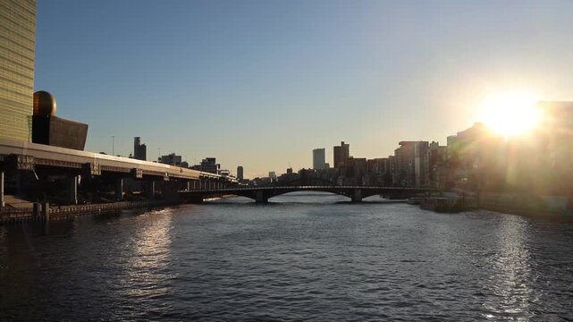 Beautiful sunset view along Sumida River with Tokyo city view as background.