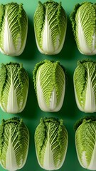 A vibrant display of fresh green cabbages on a solid green background