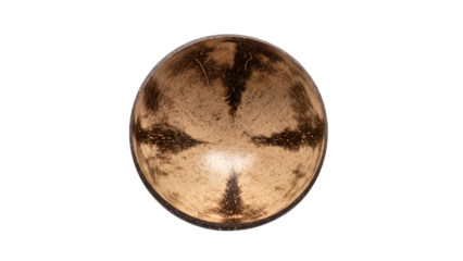 A captivating overhead shot of a spherical object, a coconut shell bowl, with unique markings  transparent background