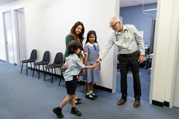 Doctor meeting family outside office
