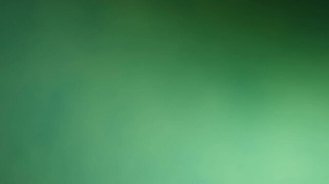 Una toma de cerca de un fondo abstracto de color verde con negro un degradado ligero desenfocado en movimiento