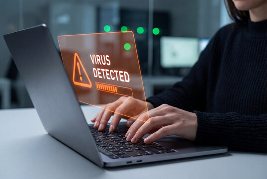 Female hands typing on laptop computer with digital virus detected warning hologram interface - Powered by Adobe
