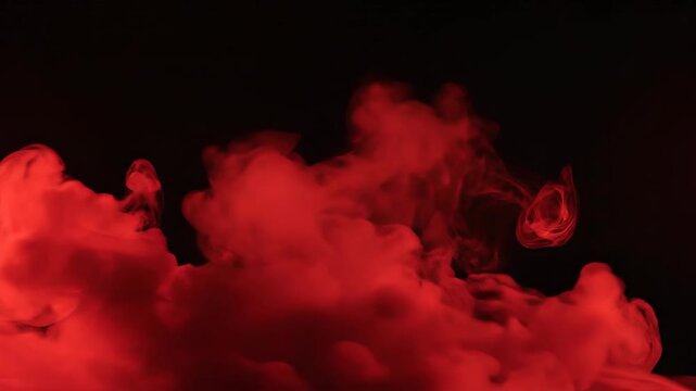 Red ink cloud rising slowly on black background for visual effects