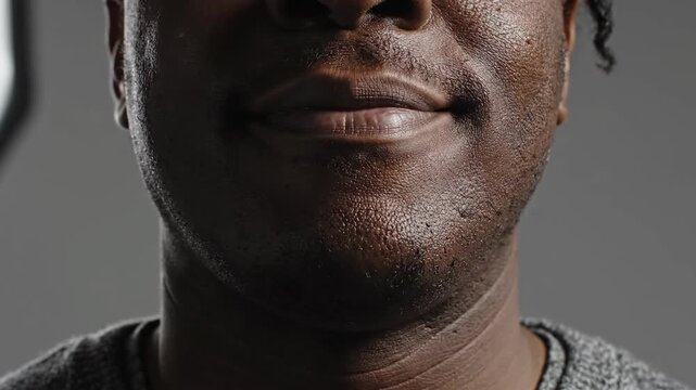 Close up portrait of a person with a neutral expression against a gray backdrop