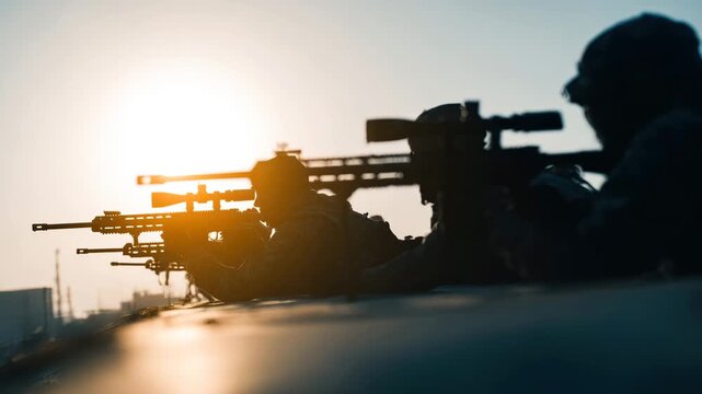 Silhouette marksmen with rifles aiming at sunset, military soldiers in tactical gear preparing for combat with focused posture and tense atmosphere