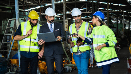 Industrial Engineers and Manager Discussing Production Plan in Factory