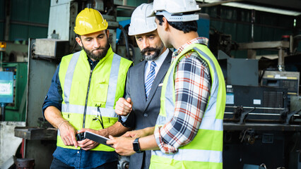 Industrial Engineers and Manager Discussing Production Plan in Factory