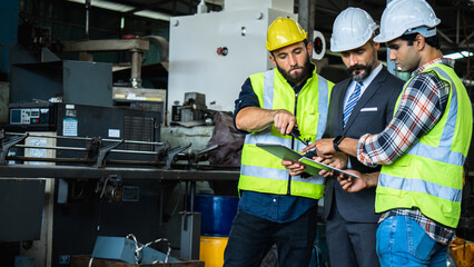 Industrial Engineers and Manager Discussing Production Plan in Factory