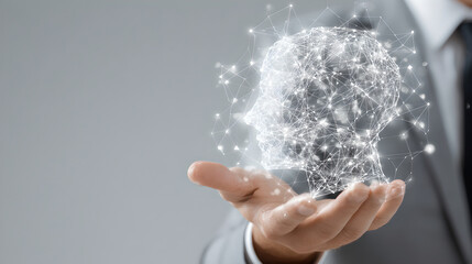 Business professional hand holding glowing digital human head hologram with mesh lines 