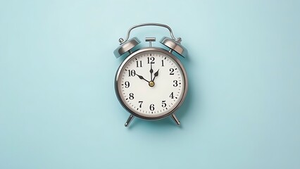 Classic alarm clock flat lay on pastel blue background