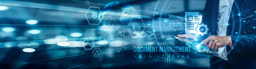 Obraz premium A businessman using a tablet is analyzing document management by organizing, storing, and securing files digitally, improving collaboration, and easy retrieval for efficient business operations.