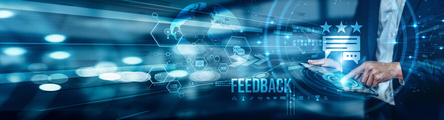 A businessman using a tablet is analyzing feedback by collecting customer and employee responses,...
