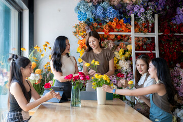 Women florists creating flower arrangements in workshop