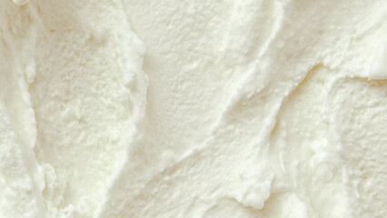 Creamy white ice cream texture with smooth swirls and soft ridges, rich and cold appearance, close-up macro view, dessert and frozen treat background.