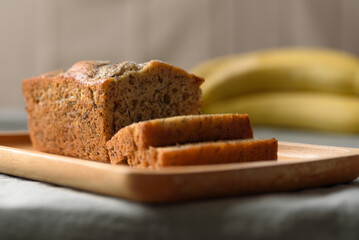Delicious homemade banana bread or cake on rustic wooden plate