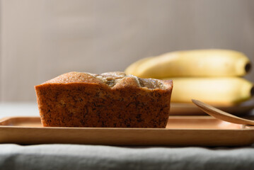 Delicious homemade banana bread or cake on rustic wooden plate