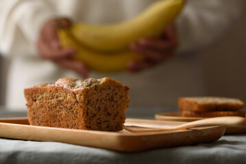 Delicious homemade banana bread or cake on rustic wooden plate