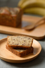 Delicious homemade banana bread or cake on rustic wooden plate