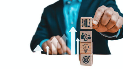 Professional upskilling and career growth concept with businessman holding stacked wooden cubes labeled SKILLS, innovation, teamwork and target, combined with rising arrows to symbolize training, comp