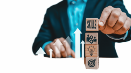 Professional upskilling and career growth concept with businessman holding stacked wooden cubes labeled SKILLS, innovation, teamwork and target, combined with rising arrows to symbolize training, comp