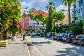 Obraz premium A colorful tree and flower lined street in the seaside city of Kusadasi, Turkey.