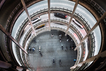 Aerial view of a multi-story spiral parking garage in the city.