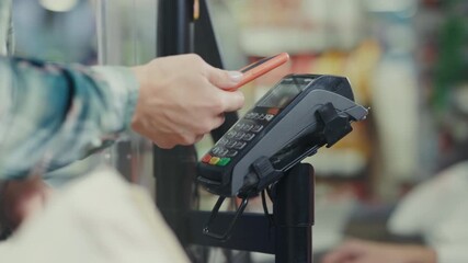 Individual swiftly completes secure contactless payment using smartphone at bustling store checkout counter