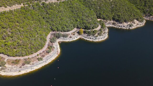 High aerial orbit shot of Lake Travis shoreline